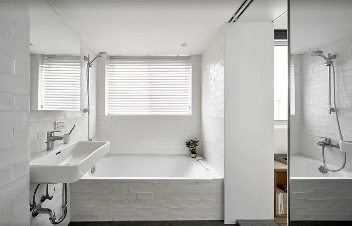 Very small studio apartment bathroom with natural light and window