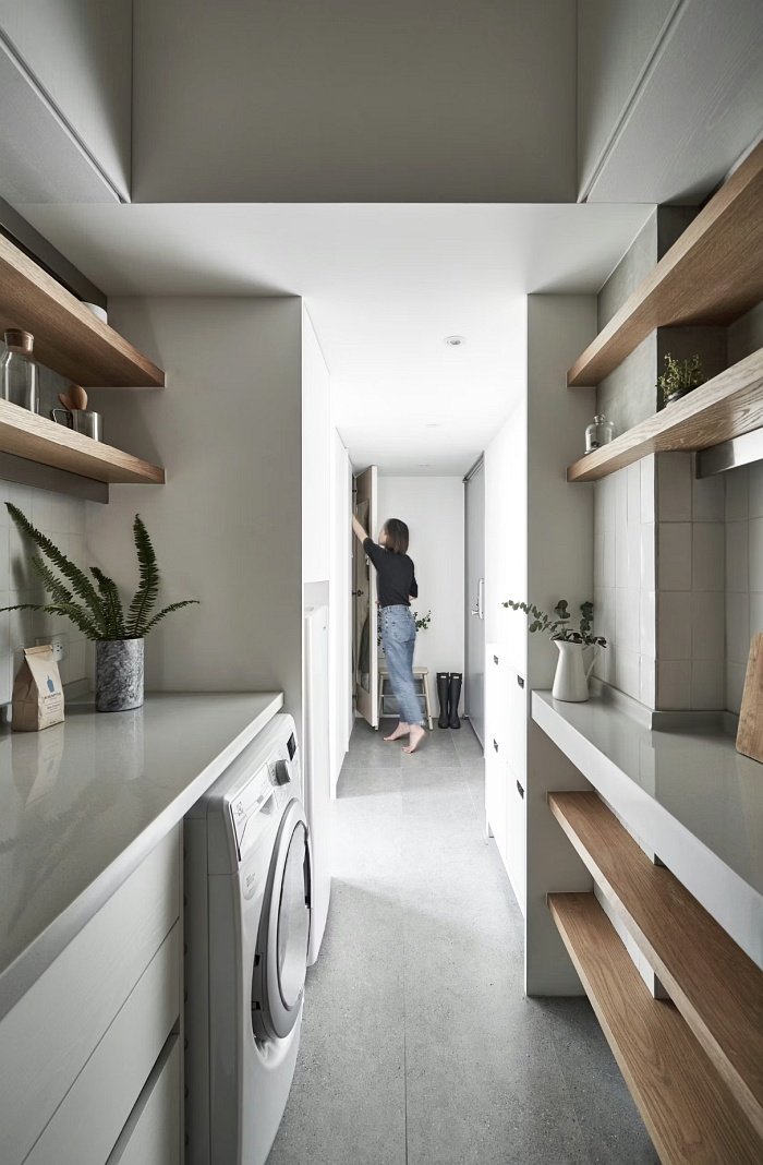 Very small studio apartment kitchen with open shelving and storage