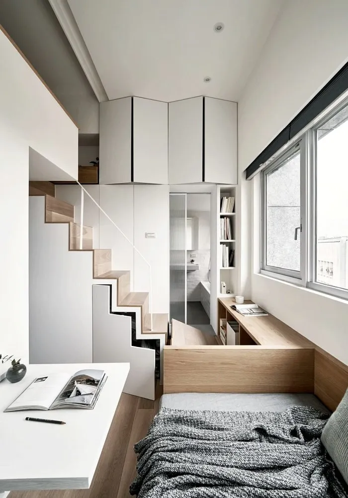 Very small studio apartment layout featuring stairs and compact living zones