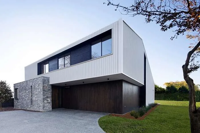 Exterior facade of a modern barn style house in Melbourne with distinctive metal cladding and barn-like form.