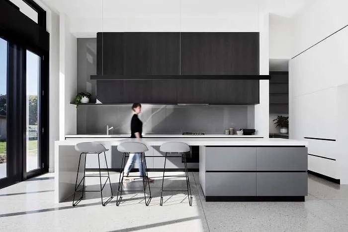 Minimalist black and grey kitchen, sleek black fixtures, and a clean contemporary aesthetic.