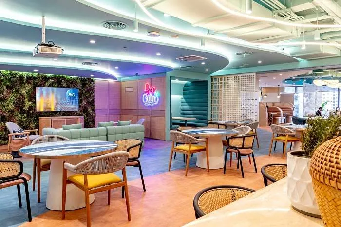 Breakout space with colorful lighting and hospitality-inspired seating.