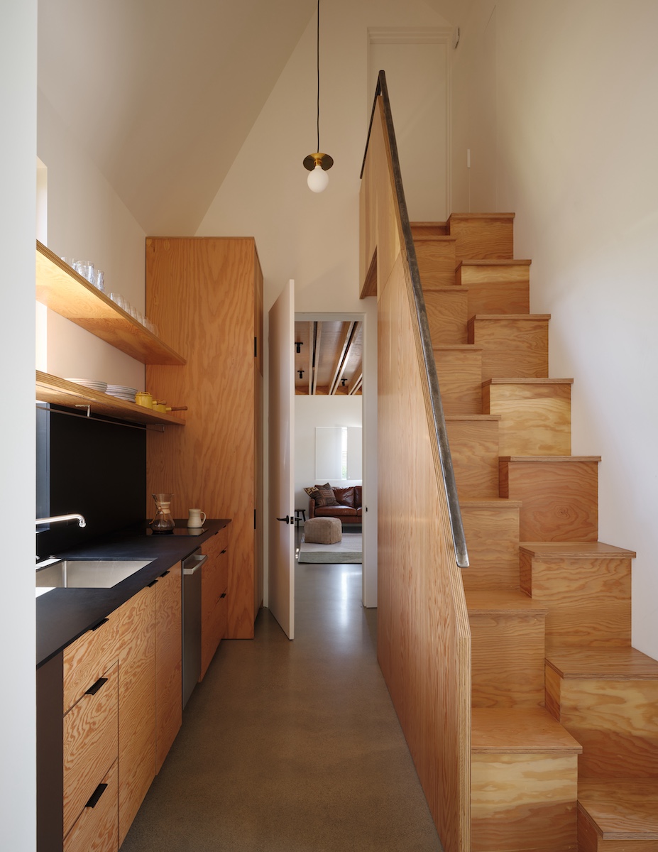 A hit-and-miss staircase leads up to the mezzanine