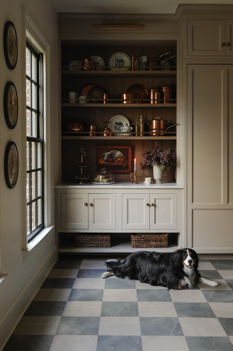 Slate & Beige Peel-and-Stick Tiles in a moody modern traditional kitchen with a mini Bernese Mountain Dog laying on top