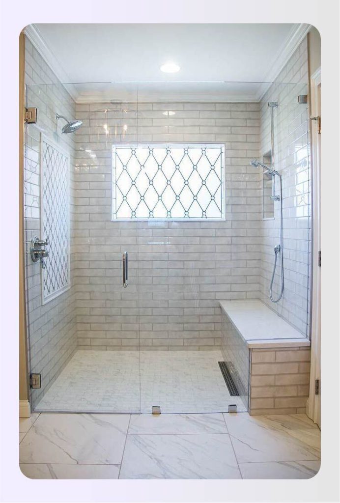 Curbless ADA shower with linear drain and glass panel