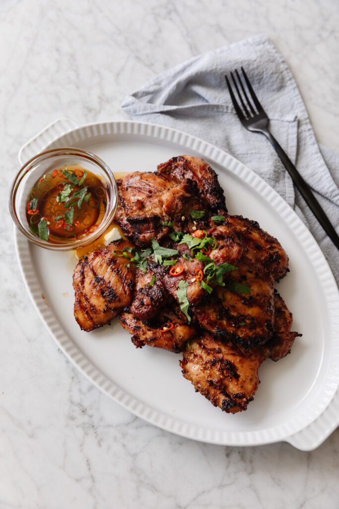 Lemongrass Grilled Chicken on a platter with dipping sauce